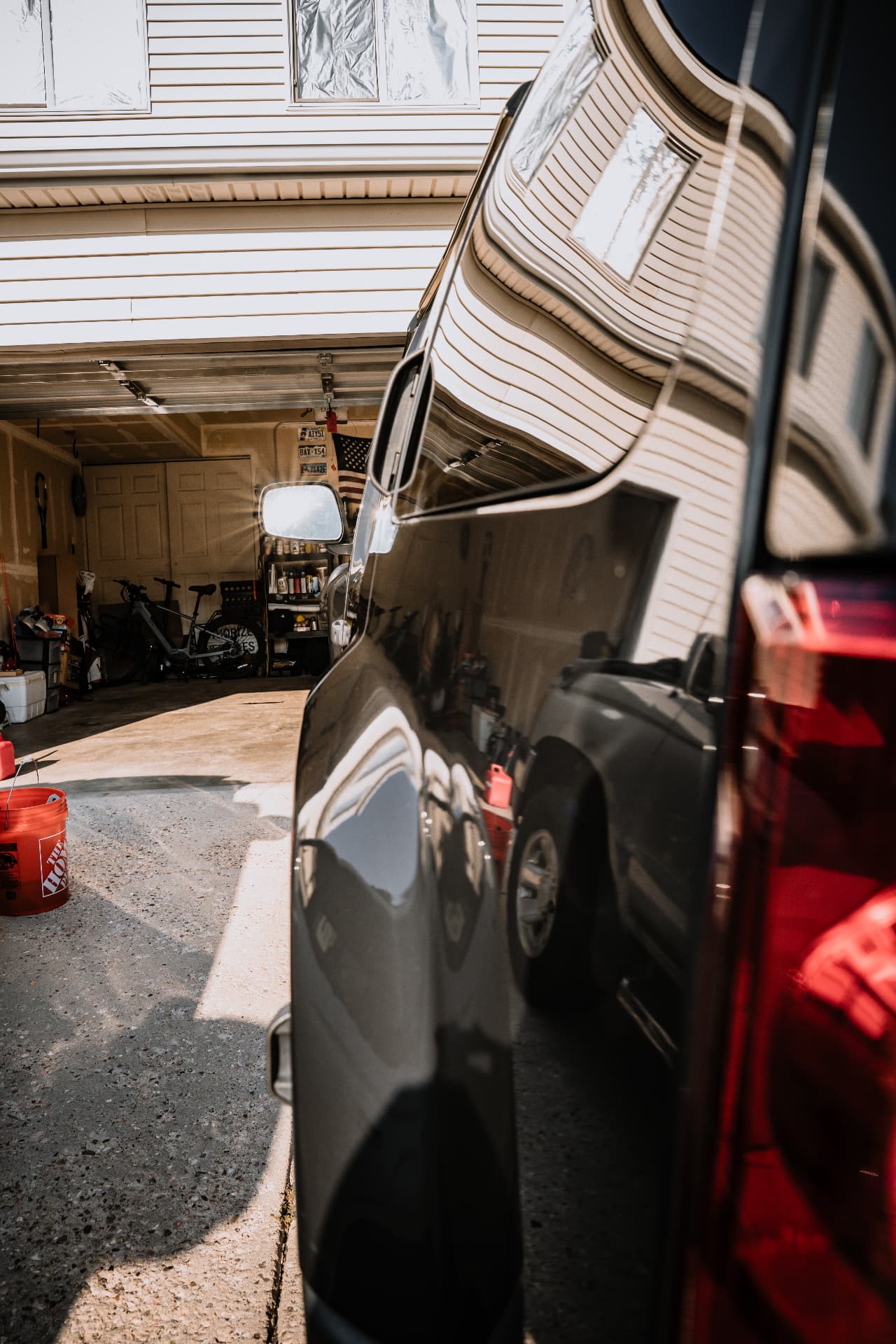 Mirror-finish black truck reflecting a Cheyenne driveway after detailing